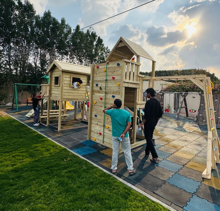 Master craftsmen working on playground equipment